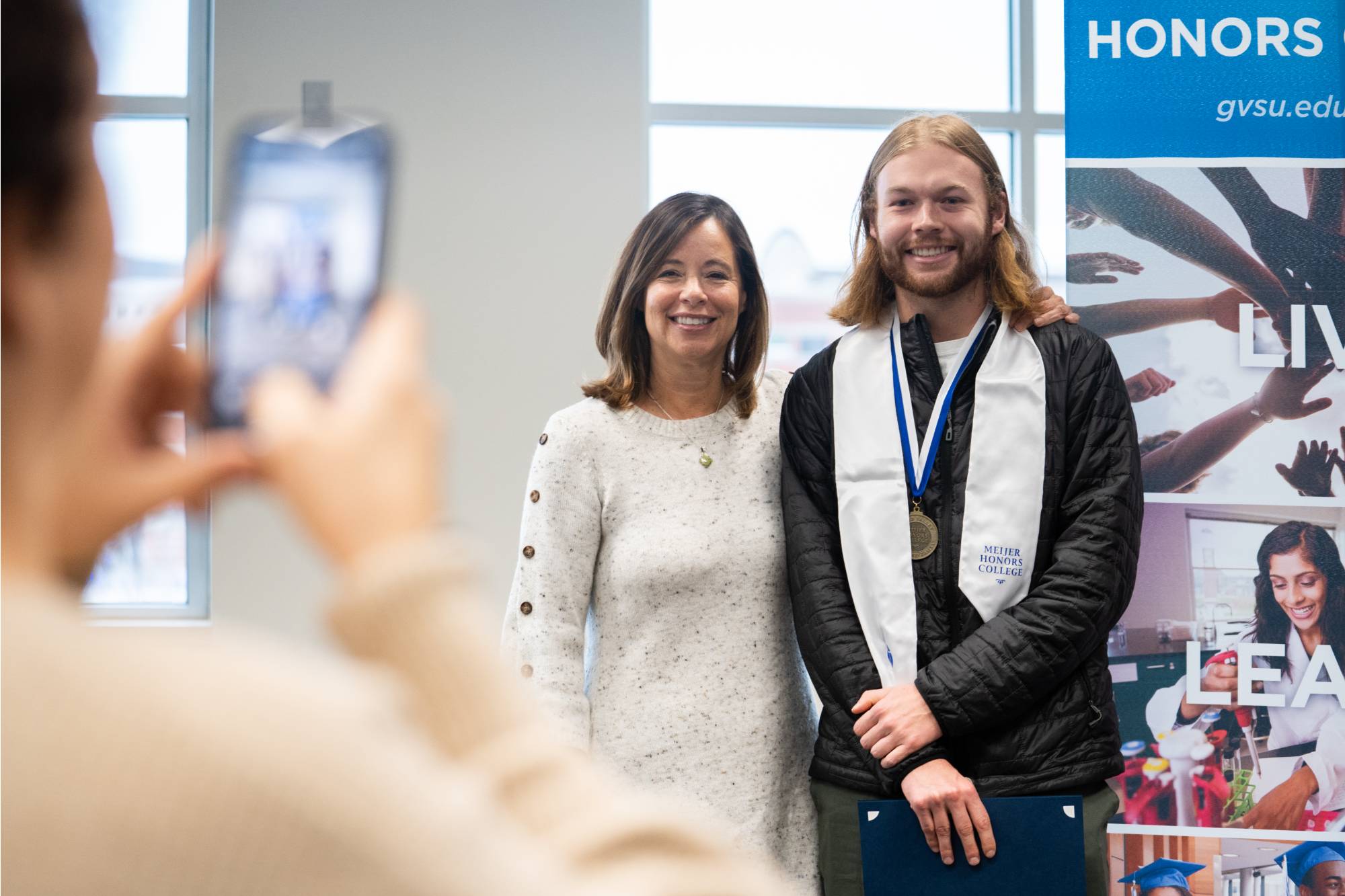 Student smiling with a supporter